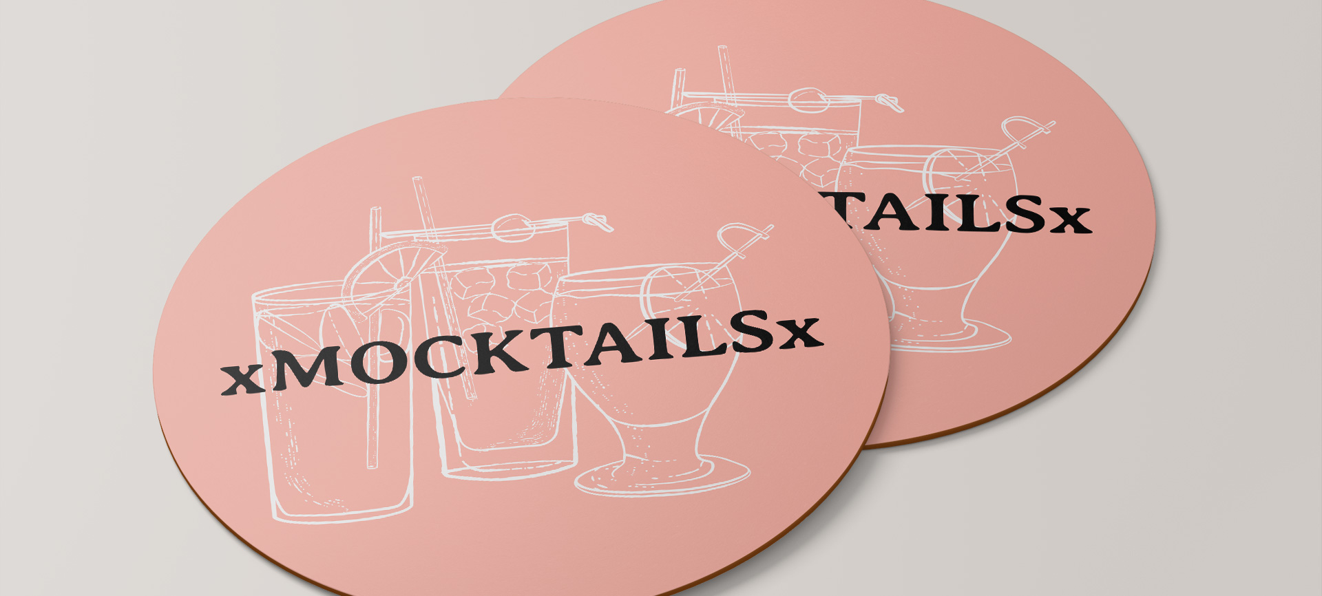 Photo of pink coasters that have 3 drinks illustrated on them